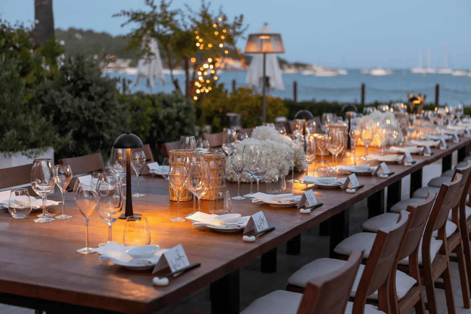 Nobu Hotel Ibiza Bay: Long candlelit dinner table on the terrace at dusk