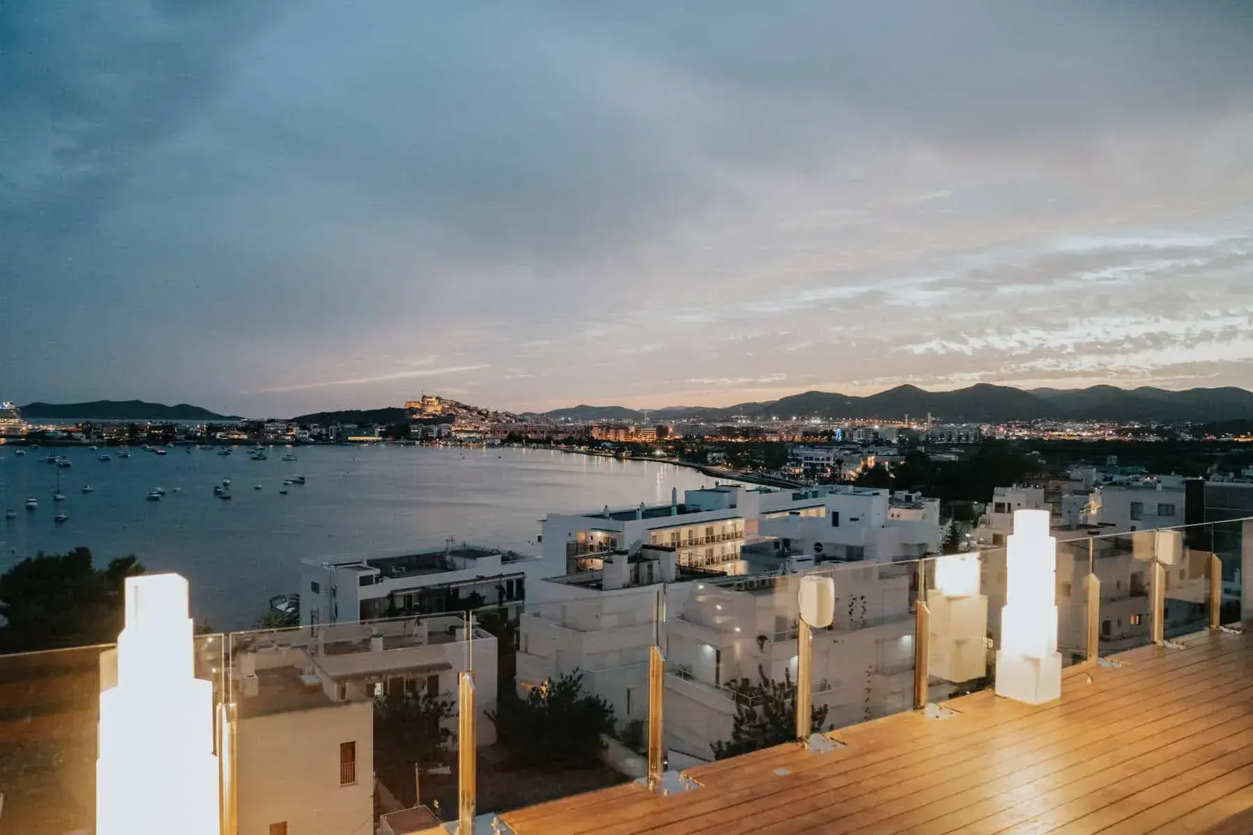 Ocean Drive Talamanca: Rooftop Sky Bar terrace at dusk overlooking Talamanca Bay and Ibiza Town