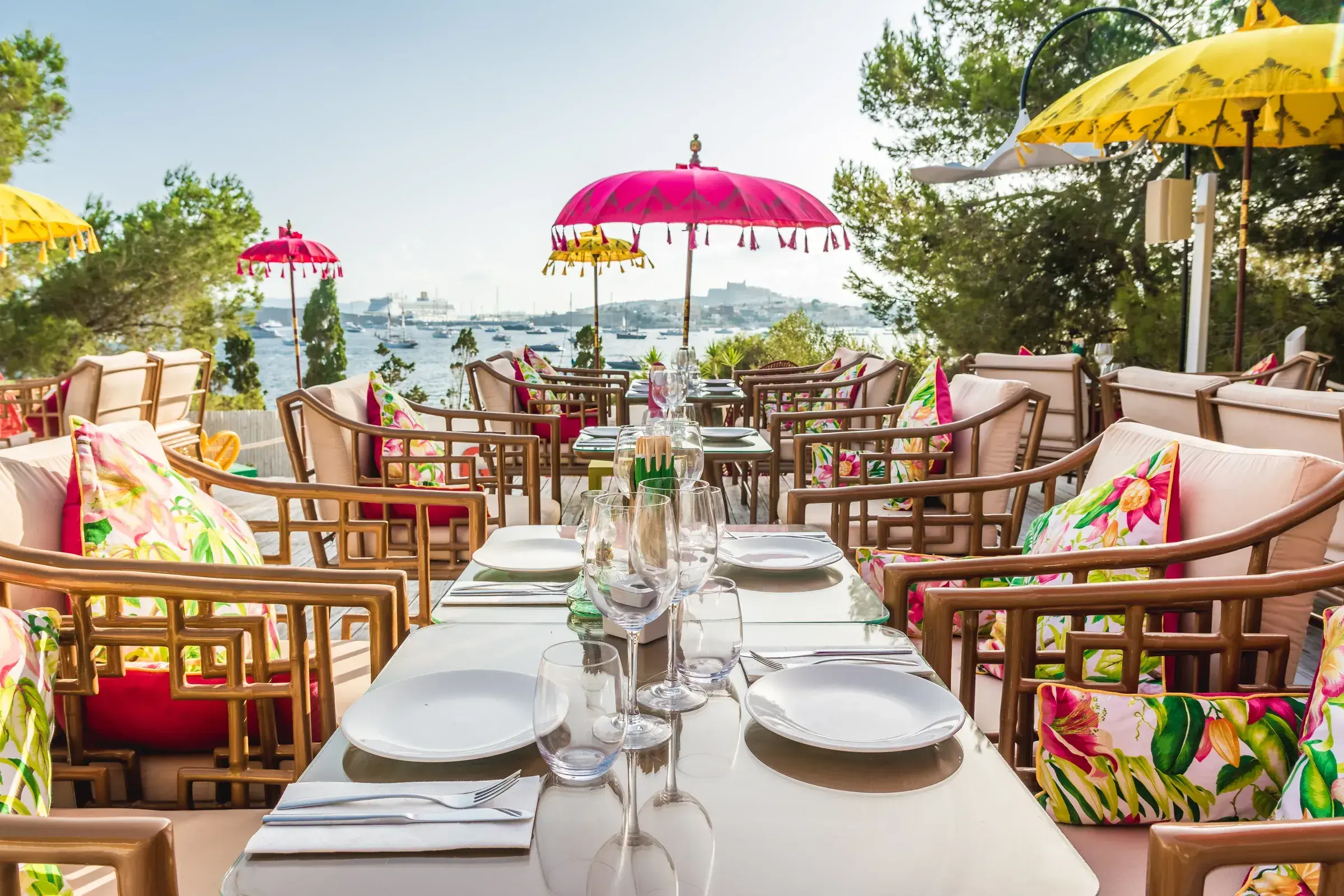 Sa Punta: Long table set under pink and yellow parasols in the Ginger private garden