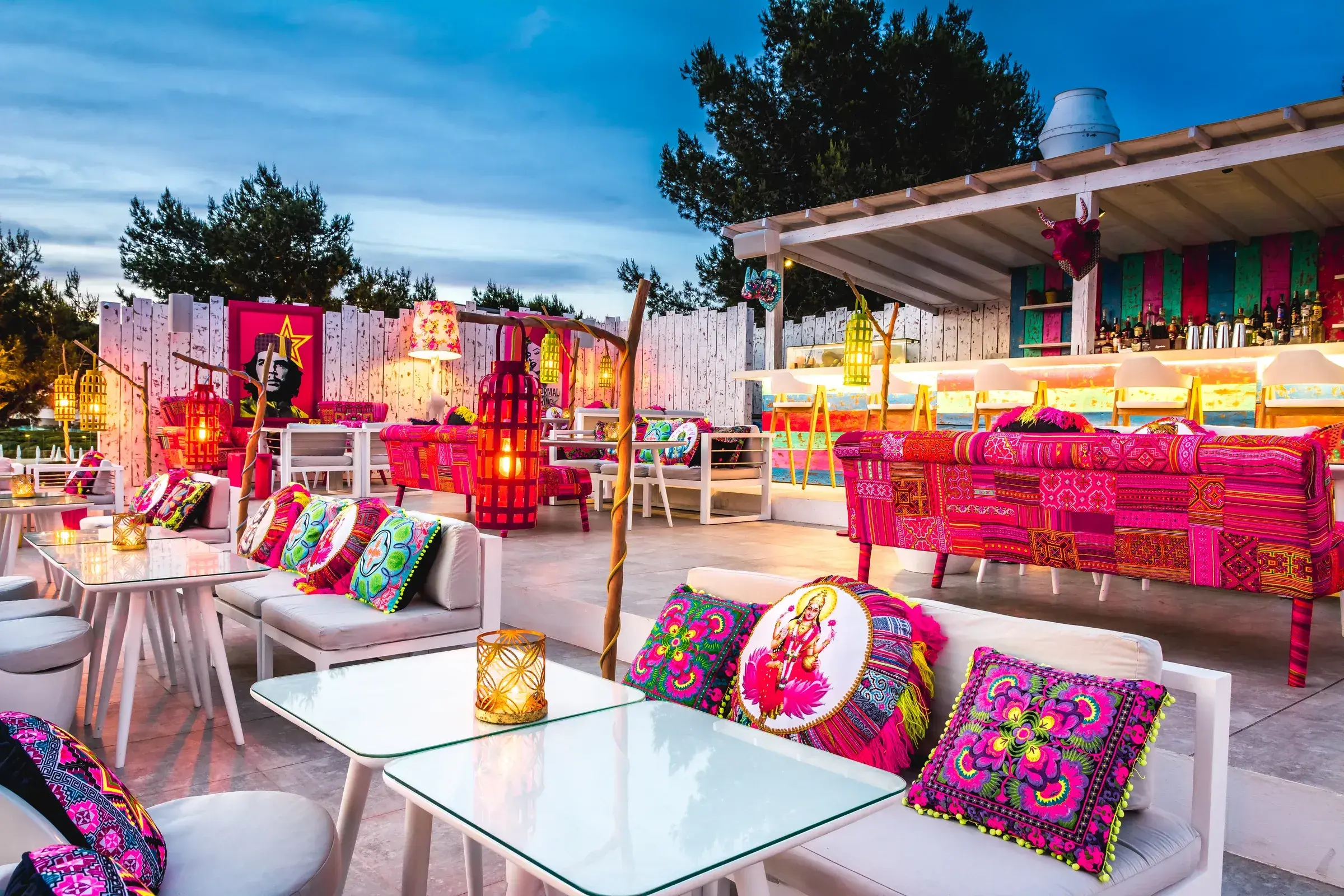 Sa Punta: Patchwork rooftop with colourful cushions and tables at sunset