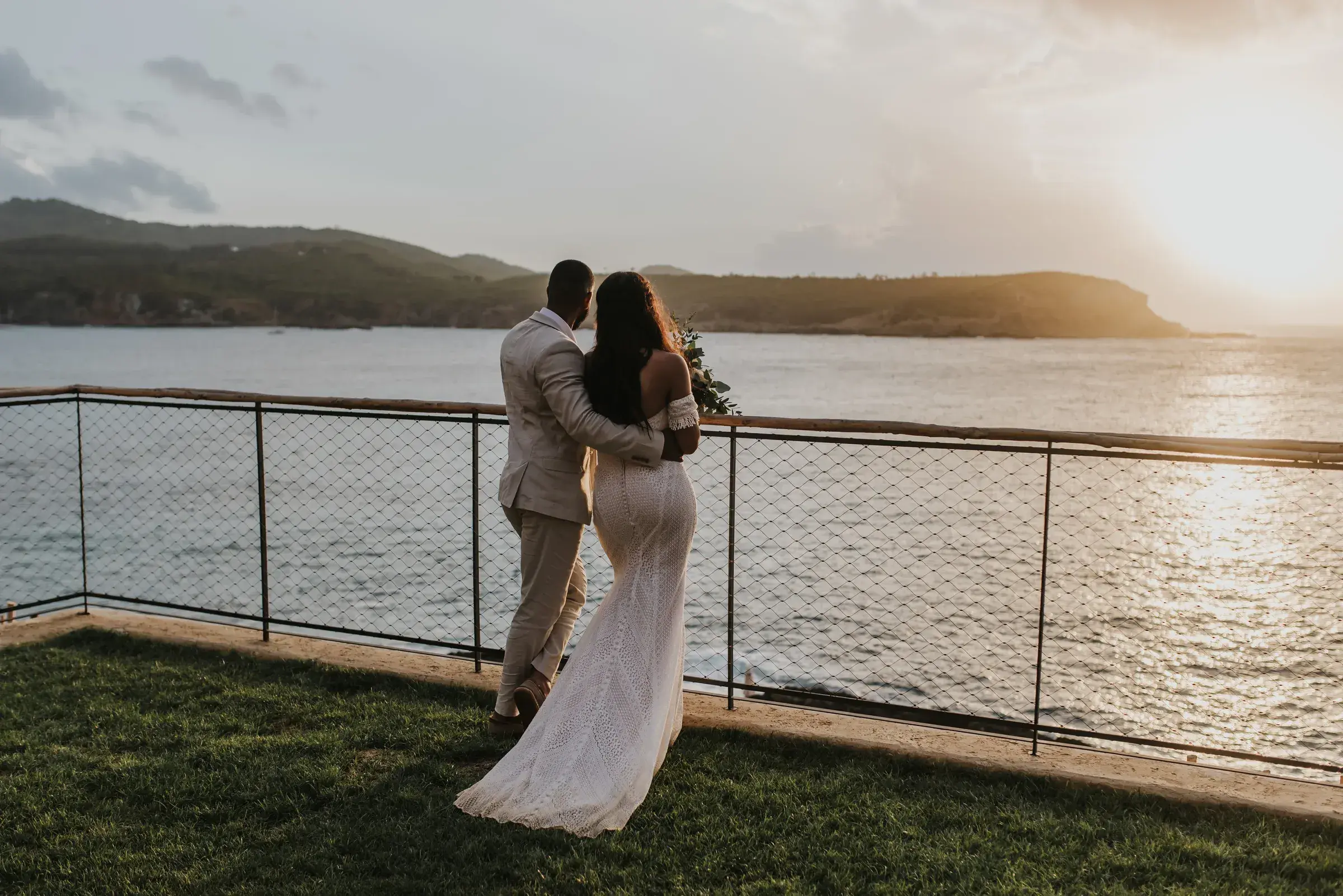 Six Senses Ibiza: Couple on the lawn by the sea at sunset