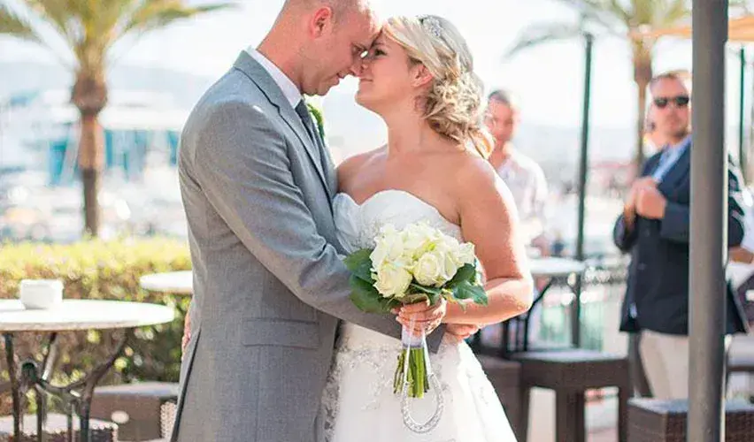 Villa Mercedes: Bride and groom embracing on the terrace by the port (852px wide)