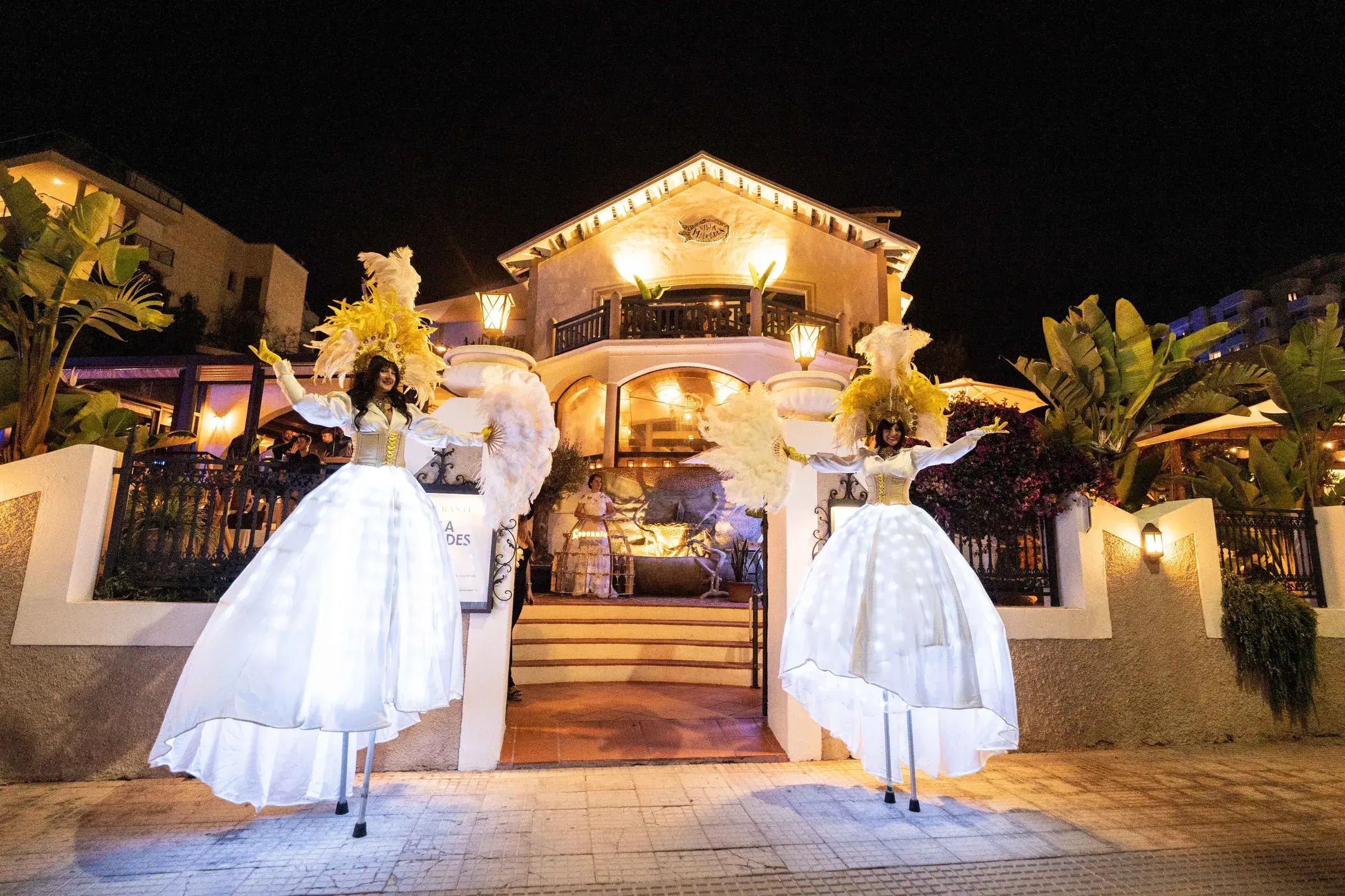 Villa Mercedes: Evening event at the villa entrance with performers in illuminated costumes