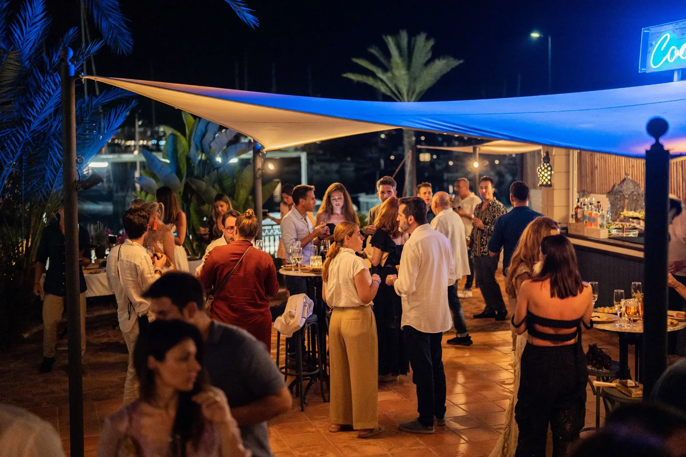 Villa Mercedes: Guests at an evening drinks event on the terrace under a shade sail