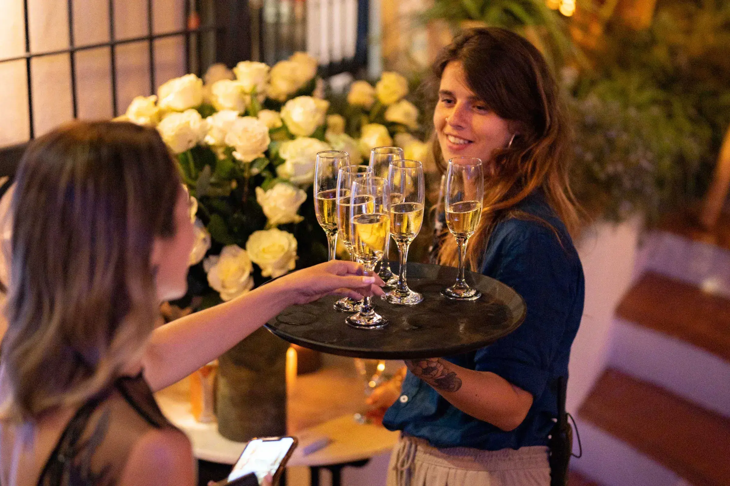 Villa Mercedes: Waiter serving champagne at a reception with white flowers