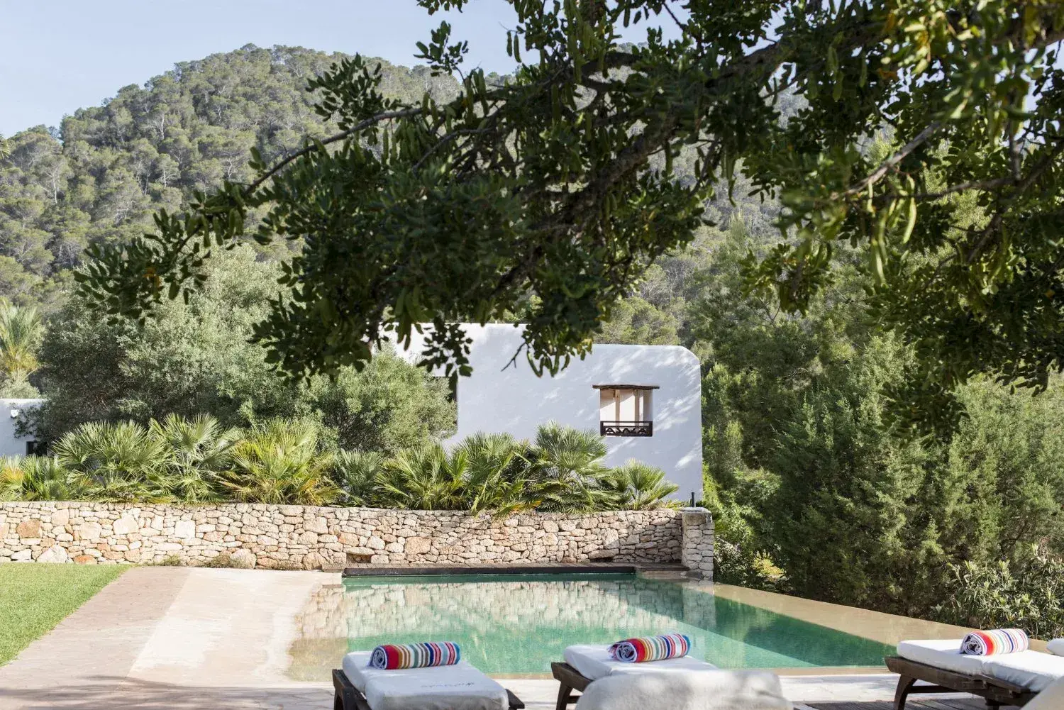 Villa Santy: Pool below the whitewashed house and garden trees