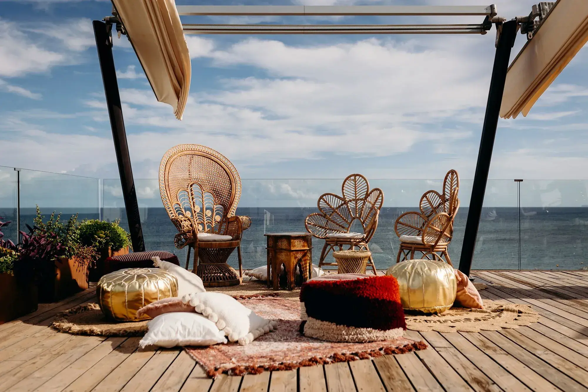 W Ibiza: Rooftop lounge set with rattan chairs, rugs and floor cushions for a pre-wedding party