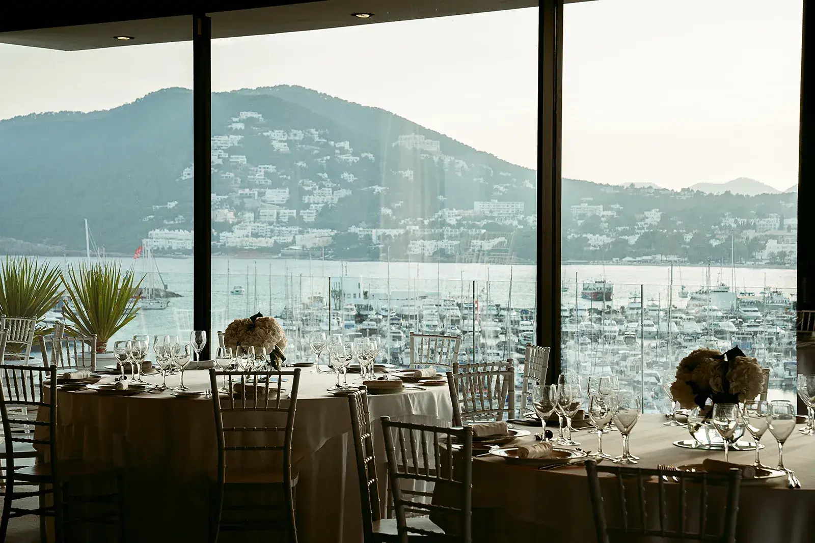 Aguas de Ibiza: Rooftop events hall set with round tables, marina view through the windows