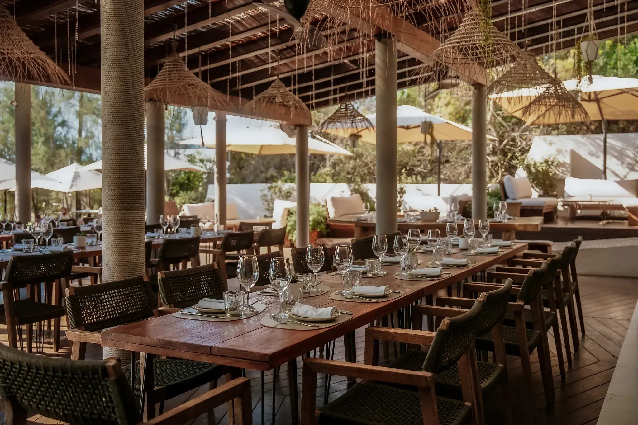 Aiyanna Ibiza: Covered restaurant with long wooden tables and woven lamps
