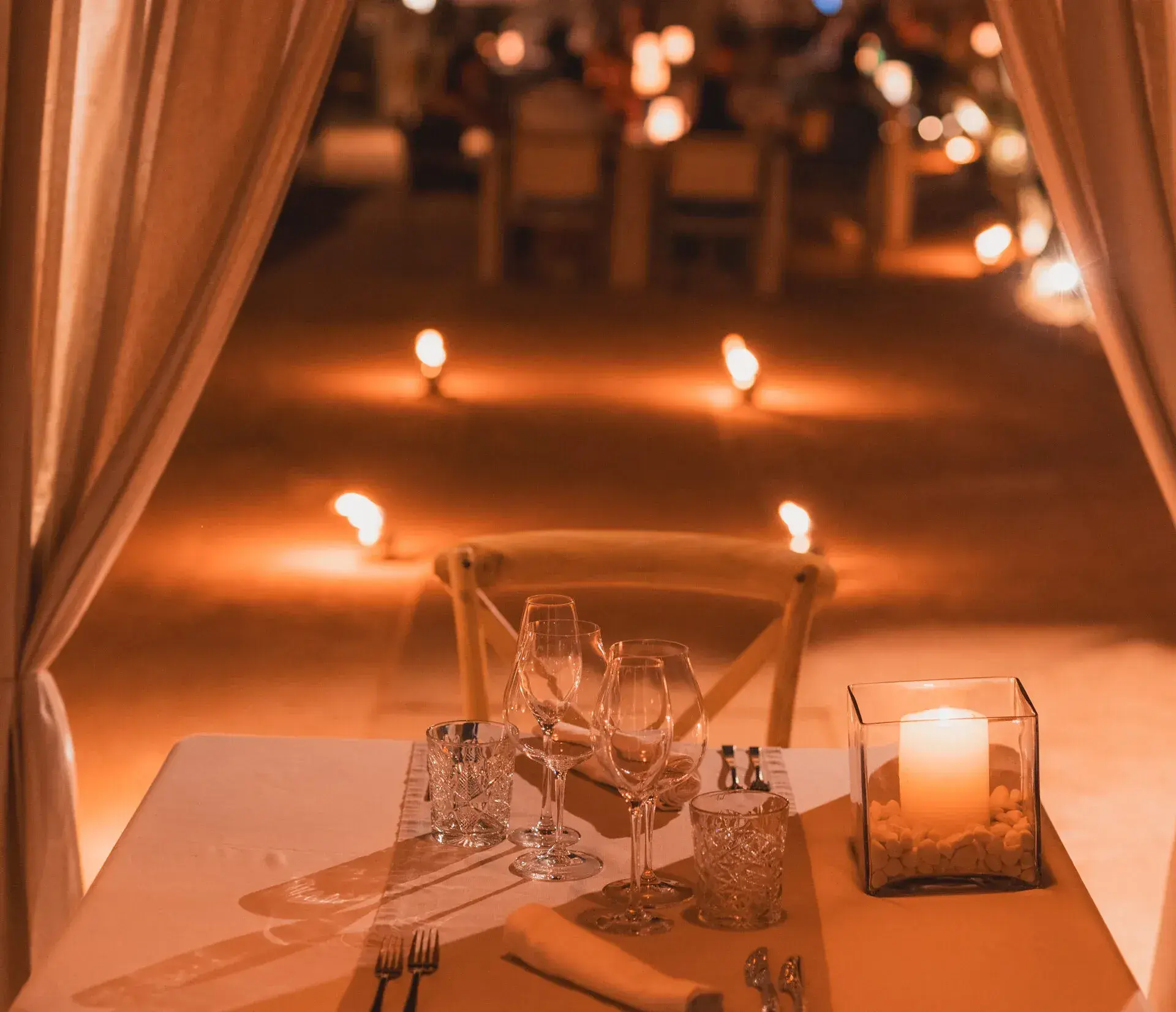 Amante Ibiza: Candlelit table at night under draped curtains