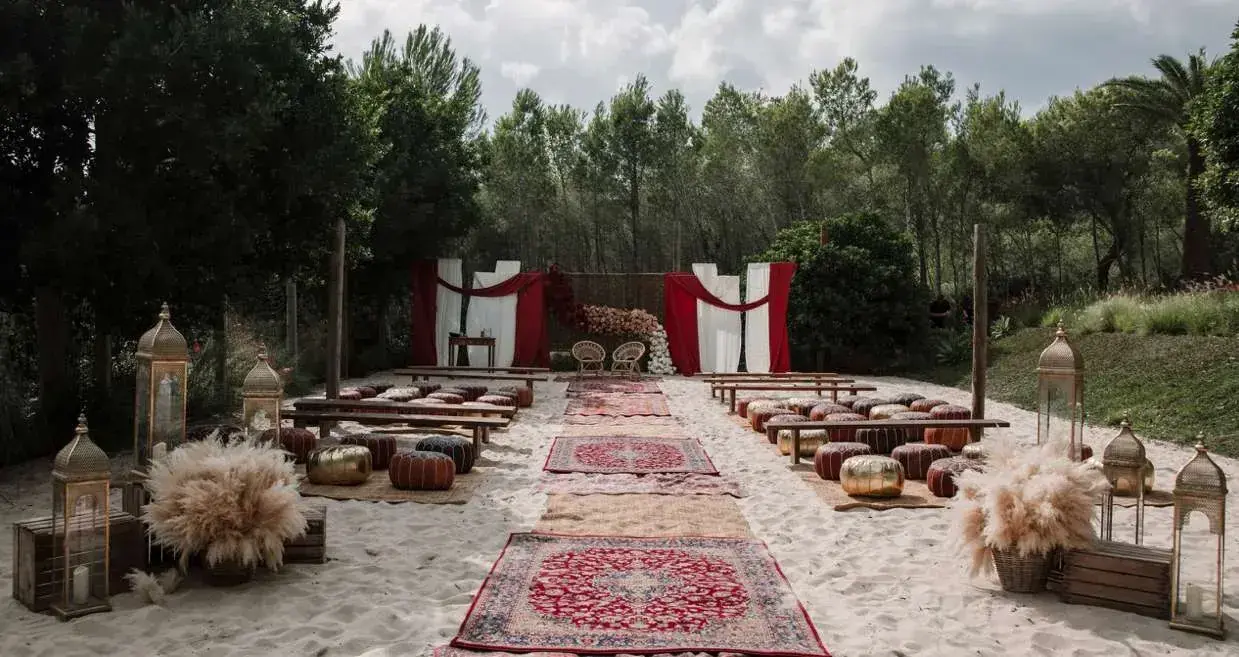 Bohemian ceremony with rugs and cushions in an Ibiza garden