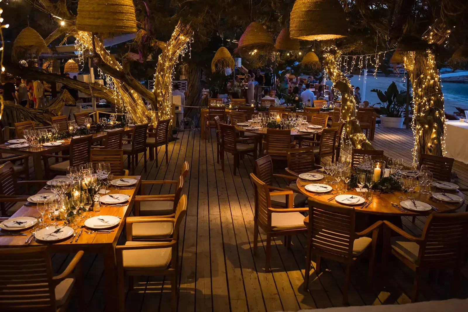 Cala Bassa Beach Club: Restaurant deck dressed for a wedding dinner with candles and lights in the trees