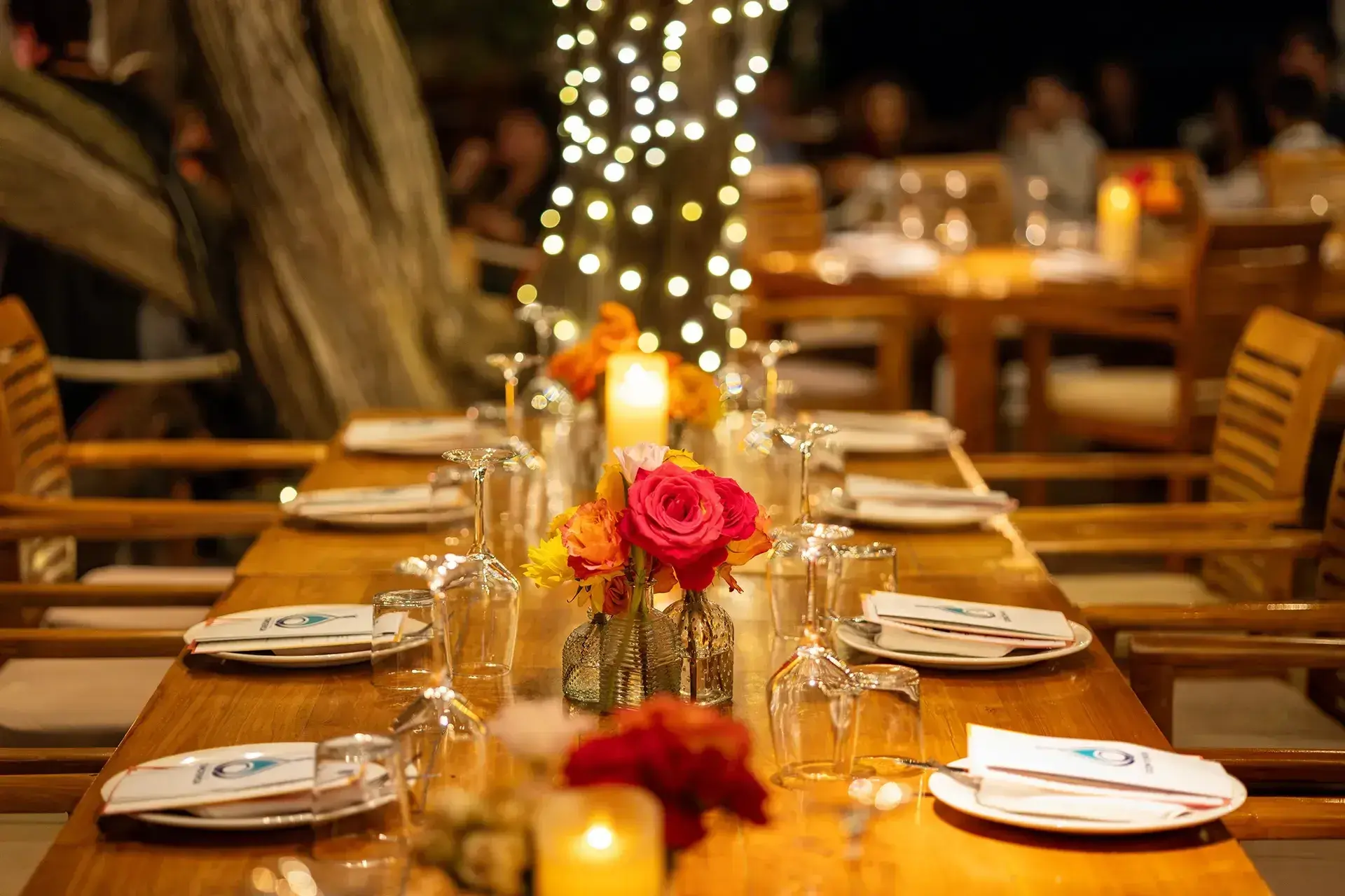 Cala Bassa Beach Club: Long candlelit table with flowers at a private dinner event