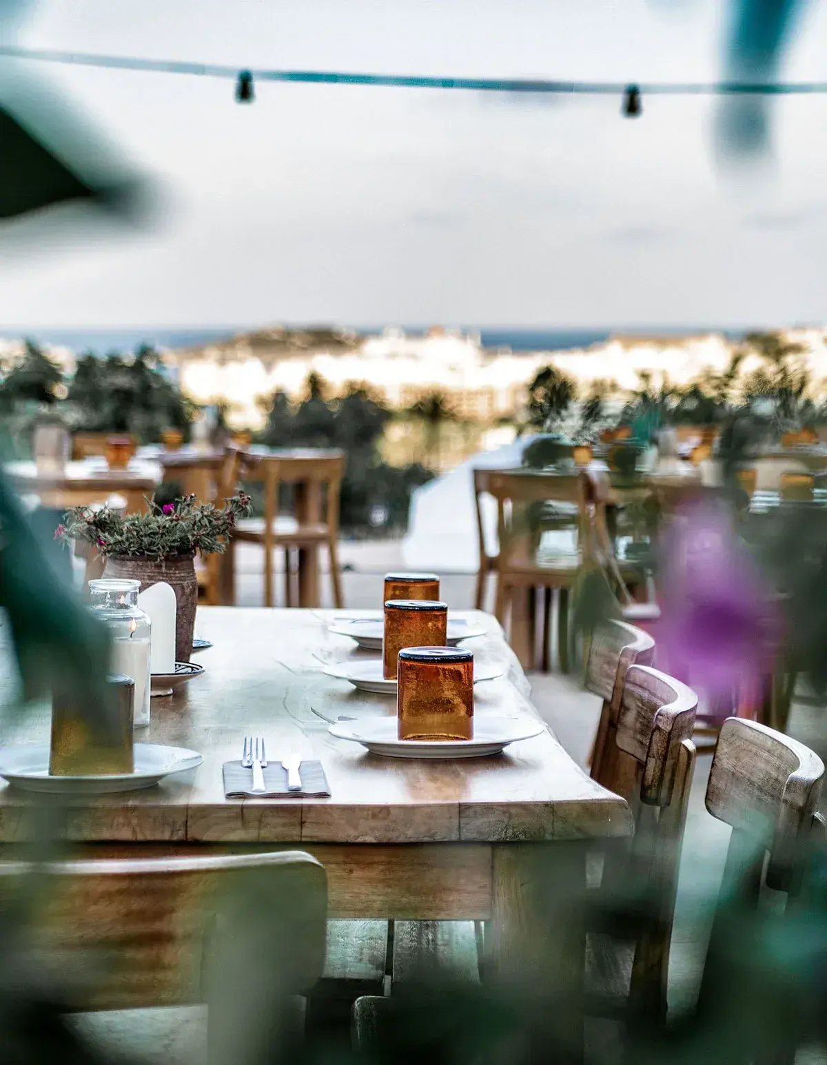 Casa Maca: Restaurant terrace with tables laid under festoon lights