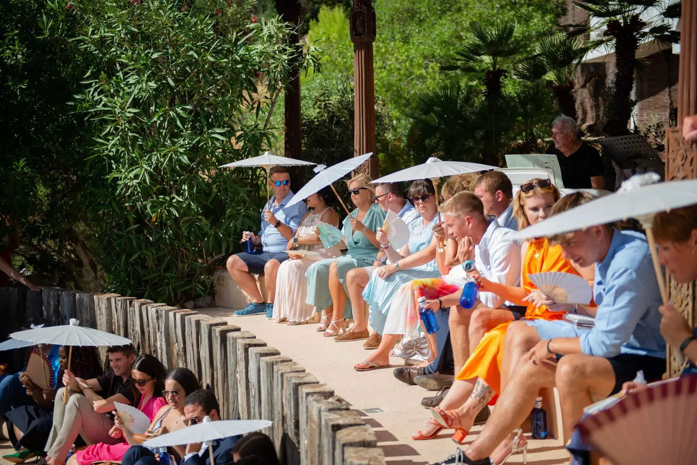 Hacienda Na Xamena: Guests with parasols on the amphitheatre's tiered seating