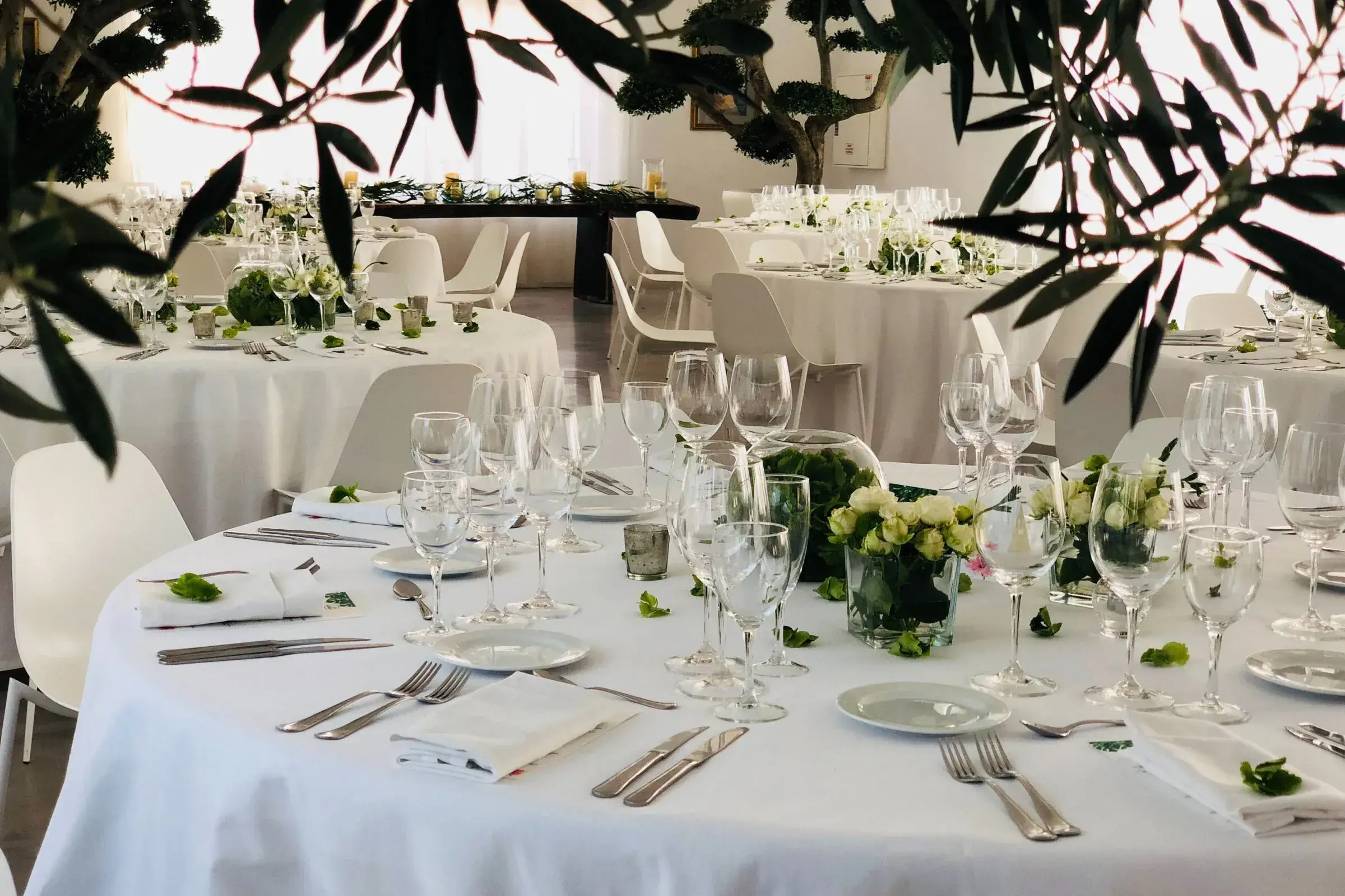 Hacienda Na Xamena: Round dinner tables in the salon framed by olive branches