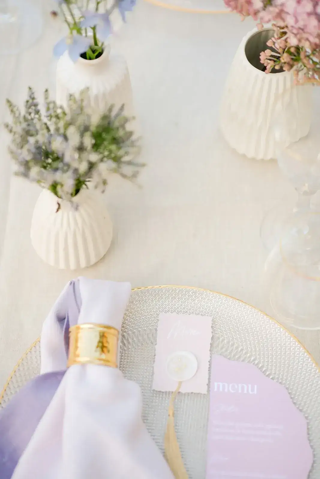 A lilac napkin and bud vases, spring styled shoot