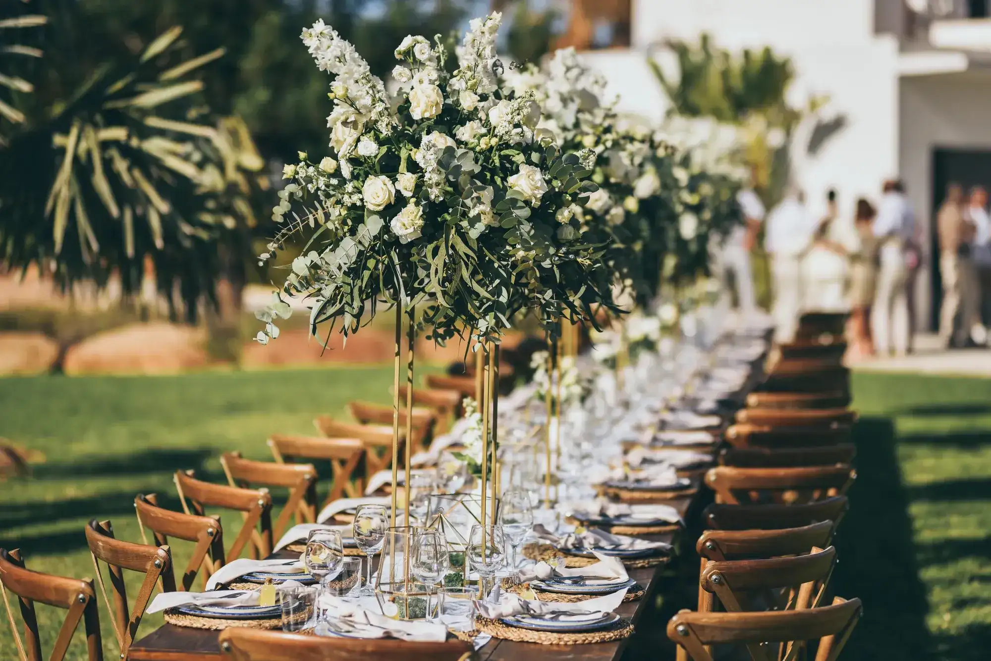 White flower towers above a long wooden table