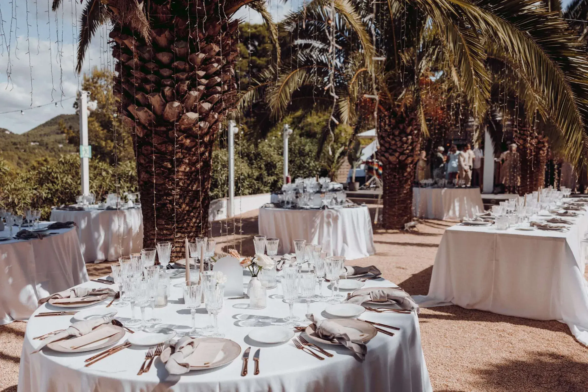 Kazamor: Dinner tables set on the terrace beneath large palms