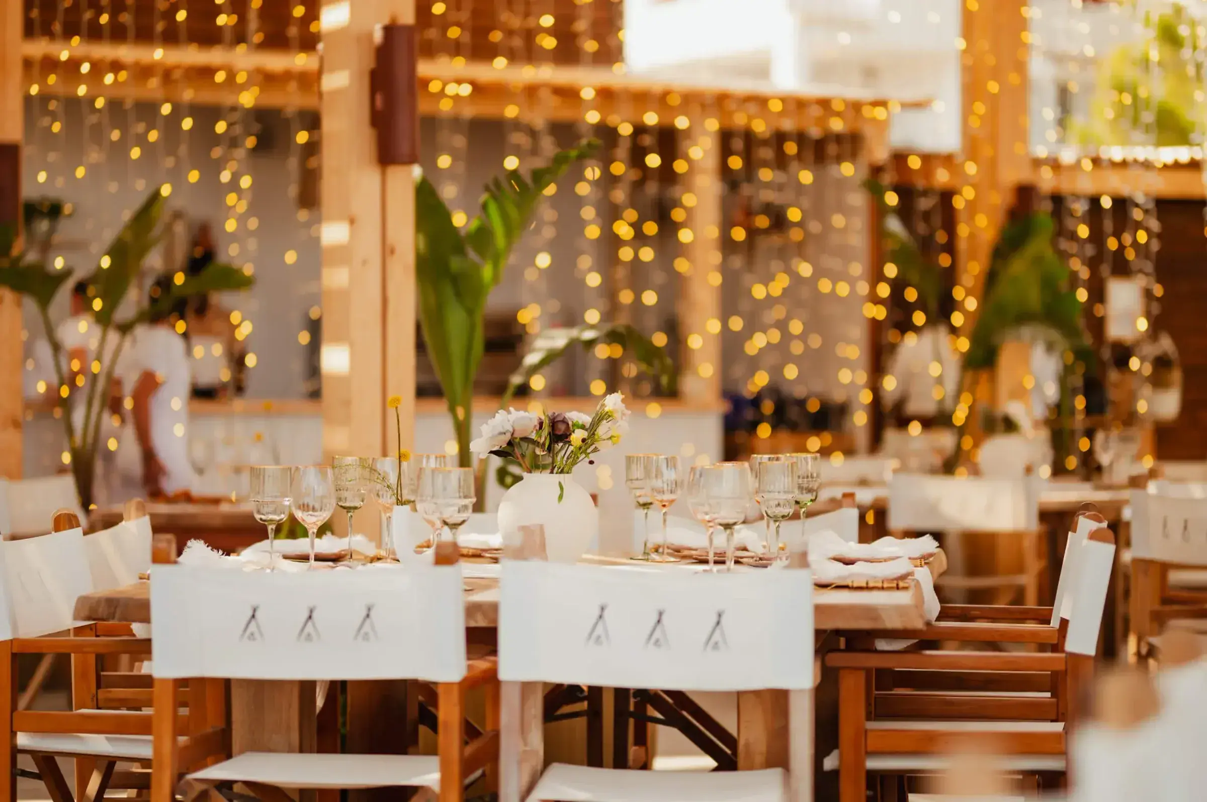 Nikki Beach Ibiza: Restaurant dressed for an event with white tablecloths, fairy-light curtains and greenery