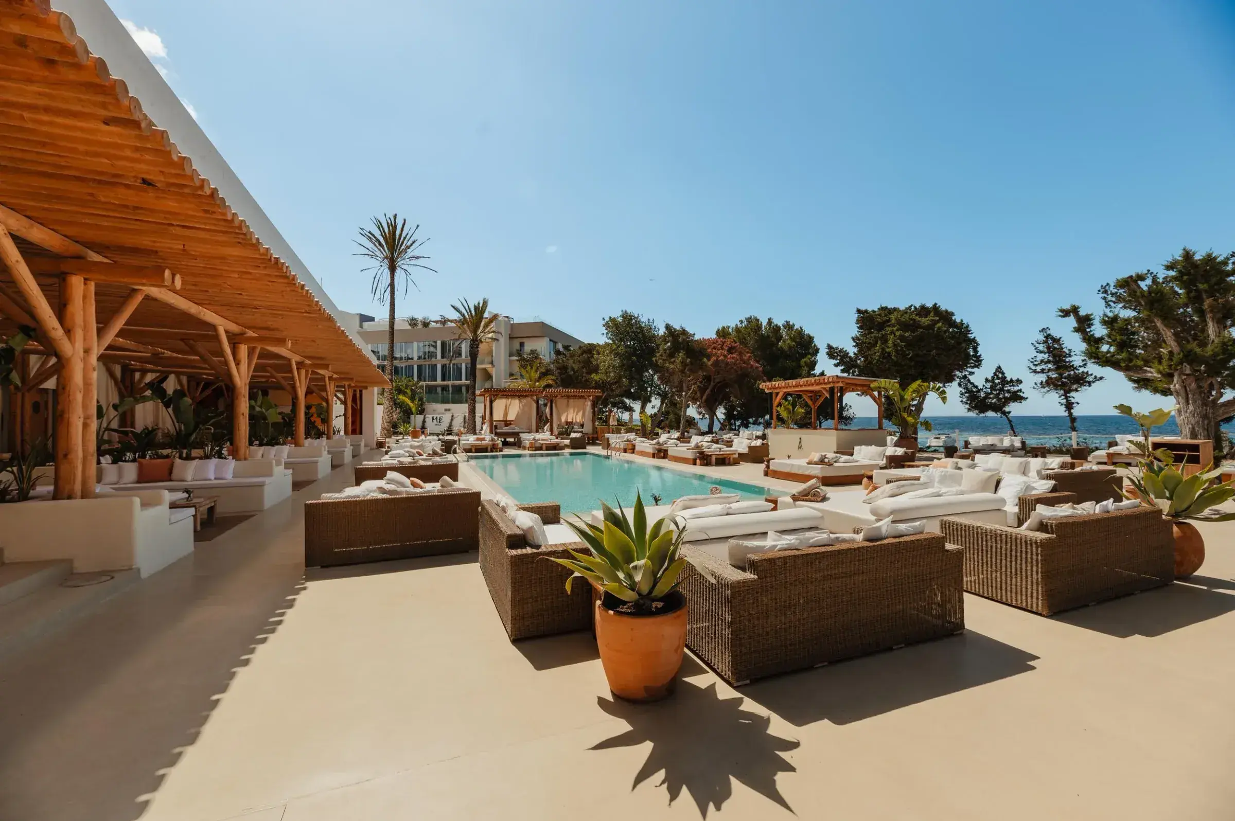 Nikki Beach Ibiza: Pool terrace with lounge seating and palms