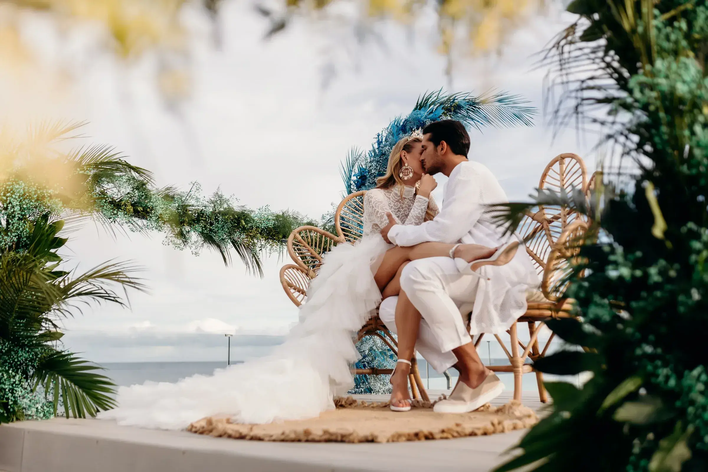W Ibiza: Couple embracing on rattan chairs among greenery on the Glow rooftop